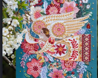May include: A beaded artwork featuring a white bird with outstretched wings, surrounded by colourful flowers and leaves on a teal background.
