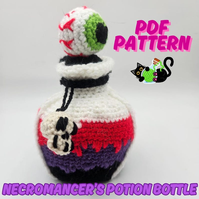 Text reads: Necromancer's Potion Bottle. Pictured is a spooky halloween style dice bag in black, purple and red. An eyeball sits on top of the cork and a small skull charm hangs from the bottle straps.
