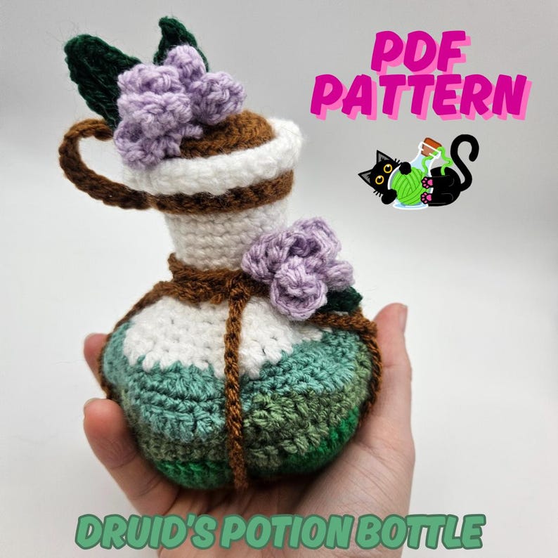 Text reads: Druid's Potion Bottle. Pictured is a round crocheted potion bottle with waves of green and purple flower, perfect for nature based characters in DnD, CnC, TTRPGs, Magic the Gathering, Ren Faire, Cosplay accessories.