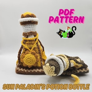 May include: Crocheted potion bottle with a sunflower design in shades of brown, yellow, and white. The bottle has a decorative necklace and is accompanied by a matching, rolled-up bottle. Text reads "PDF PATTERN" and "SUN PALADIN'S POTION BOTTLE".
