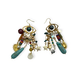 May include: Gold tone earrings with a dangling eye charm, turquoise stones, and other colourful beads.
