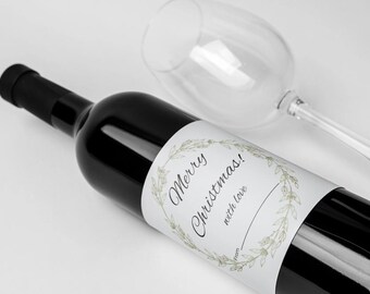 May include: A wine bottle with a white label that says "Merry Christmas! with love from" and has a green wreath design.