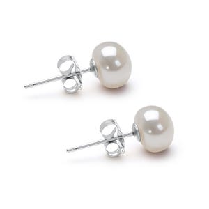 May include: A pair of stud earrings featuring round, white, lustrous pearls attached to silver-toned metal posts. Each earring includes a matching silver-toned butterfly clutch backing, showcasing a simple and classic design for ear ornamentation.