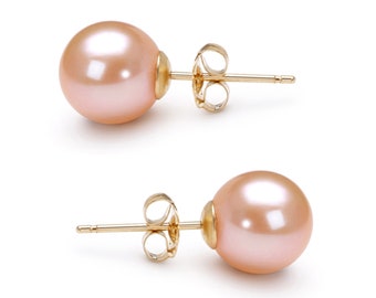 May include: A pair of stud earrings featuring round, light pink pearls with a smooth, lustrous finish. Each pearl is securely mounted on a gold-toned metal post with a matching butterfly-style friction back closure for a secure fit.