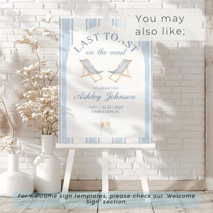 May include: A blue and white striped welcome sign with the text "Last Toast on the Coast" in a white arch. The sign also includes the text "Celebrating Ashley Johnson" and the date "May 22-25 | 2025" and the location "Charleston, SC".