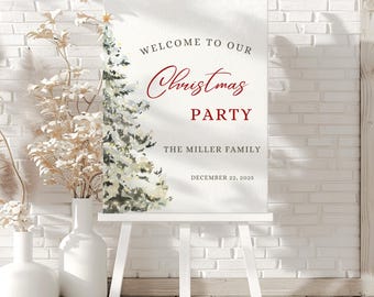 May include: A white easel displays a Christmas party welcome sign. The sign features elegant script that reads "Welcome to our Christmas Party" in red, with the family name and date below. A watercolor Christmas tree is on the left.