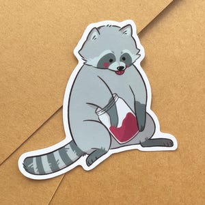 Sticker raton laveur avec confiture de fraises