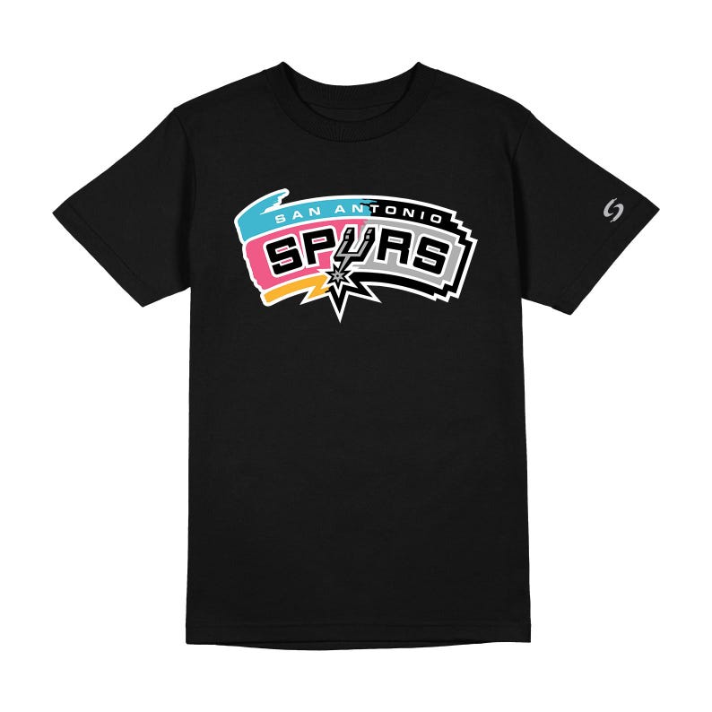 May include: Black t-shirt featuring the San Antonio Spurs logo in white, pink, blue, and yellow. The logo includes the text "SAN ANTONIO SPURS" and a star graphic. A small logo is on the right sleeve.