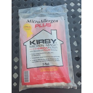 May include: A clear plastic bag containing two Kirby Micron Magic HEPA filter vacuum bags. The bag has a red and white label with the words "MicroAllergen PLUS" and "2-Pack" printed on it. The label also features the Kirby logo and product information.