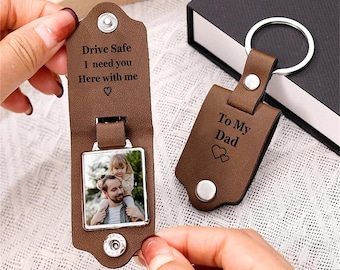 May include: Brown leather keyring with a photo insert and a message that reads "Drive Safe I need you Here with me". The keyring also has a separate tag that reads "To My Dad" with two hearts.