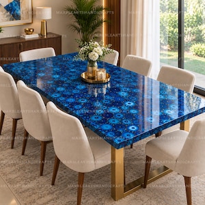 May include: A rectangular dining table featuring a polished blue gemstone surface with a repeating circular pattern, supported by a gold-toned metal base. Six upholstered chairs with light beige fabric and wooden legs surround the table.