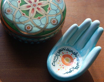 Ceramic hand has the message "Carry your sunshine with you". Hand-painted with underglazes and ready to display on a table or wall.