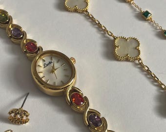 Elegant Gold Watch with Colourful Gem Accents