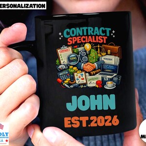 May include: Black ceramic mug with the words "CONTRACT SPECIALIST" in teal and orange. The mug features a graphic of contract-related items and the name "JOHN" with "EST.2026". The mug is proudly printed in the U.S.A.