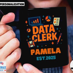 May include: Black ceramic mug with the words "DATA CLERK PAMELA EST.2025" in orange and white. The mug has colorful graphics of a laptop, pie chart, and other data-related icons. The mug is proudly printed and shipped in the U.S.A.