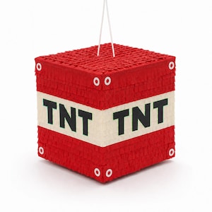 May include: A square-shaped red piñata featuring a white horizontal band across the center with the black text TNT printed on it. The surface is covered in fringed paper, and the corners are accented with white circular details and a white hanging cord.