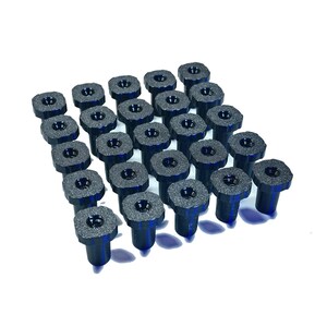 May include: A collection of twenty-five dark blue, textured, hexagonal-headed fasteners arranged in a five-by-five grid. Each fastener features a central circular indentation on the top surface and a cylindrical shaft extending downward from the head.