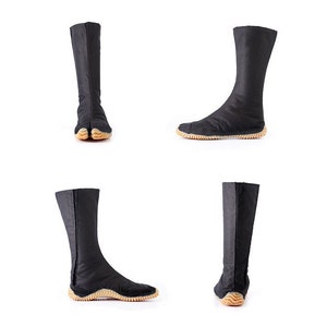 May include: Black tabi boots with a pointed toe and a textured sole. The boots are made of a soft, flexible material and have a zipper on the back.