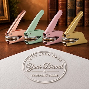 May include: Four metal handheld embossers in rose gold, mint green, light pink, and gold finishes. A white piece of paper in the foreground features a circular embossed design with the text YOUR LOGO HERE, Your Brand, and COMPANY NAME.