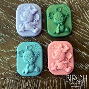 May include: Four rectangular soaps featuring cartoon characters. The soaps are lavender, green, blue, and pink. The soaps feature Baby Mickey and Baby Minnie Mouse. The text on the soaps reads "Baby Mickey" and "Baby Minnie".