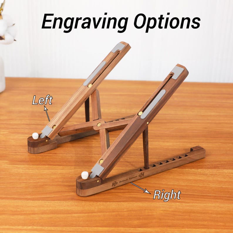 May include: Two wooden laptop stands with adjustable angles. The stands are made of dark wood with silver accents and are shown on a wooden surface. The text "Engraving Options" is at the top of the image.