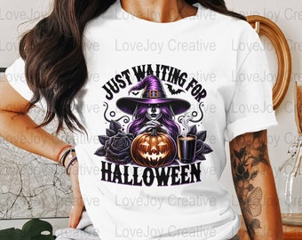 May include: White t-shirt featuring a Halloween-themed graphic. The design includes a witch with purple hair and a hat, a jack-o'-lantern, and the text "JUST WAITING FOR HALLOWEEN". The design also includes black roses and a cup of coffee.