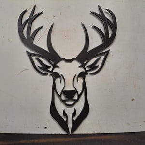 May include: Black metal deer head wall decor with intricate antlers.