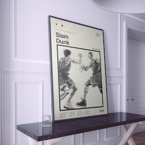 May include: A black and white poster with the title "Slam Dunk" in red and white text. The poster features two basketball players in action, with the text "Toei Animation Production" at the top.