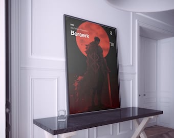 May include: Framed poster featuring a dark silhouette of a figure with a large sword, set against a red moon. The word "Berserk" is prominently displayed, with additional text above. The poster is in a black frame and rests on a dark marble table.