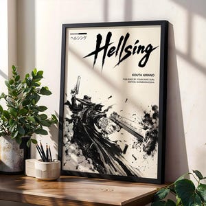 May include: A framed Hellsing poster featuring a black and white illustration of a character in a long coat and hat holding two large handguns. The text reads Hellsing, Kouta Hirano, Published by: Young King Ours, Edition: Shonengahosha, and Japanese text.