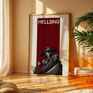 May include: A rectangular wall poster in a thin gold frame featuring the word HELLSING in white capital letters at the top. Below the text is a dark red vertical panel containing a black and white illustration of a character in a wide-brimmed hat.