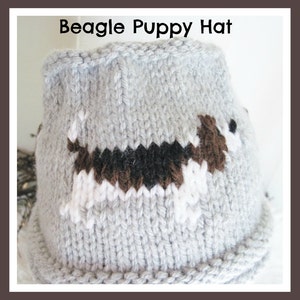 May include: A light gray knitted hat with a beagle puppy design. The hat features a detailed image of a beagle in brown, black, and white. The text "Beagle Puppy Hat" is displayed at the top of the image.