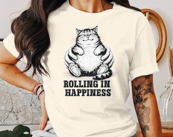 May include: A white t-shirt with a black and white illustration of a cat with the text "Rolling in Happiness".