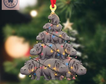 May include: A Christmas tree ornament shaped like a tree made of gray hippos, strung with colorful lights. The ornament hangs from a red ribbon. The text "2D FLAT ITEM" is at the bottom.