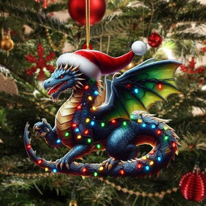 May include: A blue dragon Christmas ornament wearing a Santa hat and wrapped in colorful Christmas lights. The dragon has green and yellow wings and is hanging from a gold string. Red Christmas ornaments and a Christmas tree are in the background.