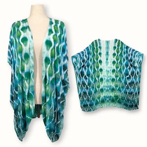 May include: A tie-dye kimono and matching top in shades of blue, green, and white. The kimono is open-fronted with short sleeves, while the top has a similar pattern. The fabric features a repeating pattern of interconnected shapes, creating a unique visual texture.