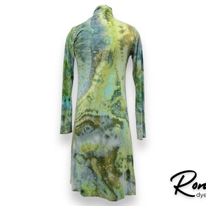 May include: A long-sleeved, green, blue, and white tie-dye tunic dress with a high neck.