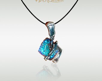 May include: A silver necklace with a blue and silver pendant. The pendant is made of glass and has a unique, abstract design.