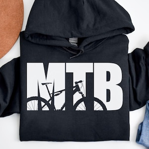 May include: Black hooded sweatshirt with a white graphic of a mountain bike with the text "MTB" on it.