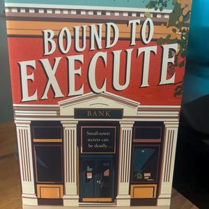 May include: The book cover for "Bound to Execute" by ACF Bookens. The cover shows a stylized illustration of a bank building with the title in large white letters. The text "Small-town secrets can be deadly..." is also visible.