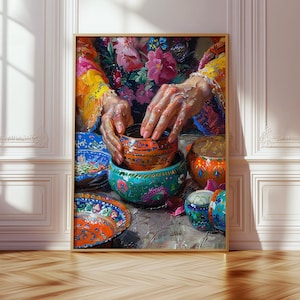 May include: A framed painting depicts hands arranging colorful, patterned bowls. The artwork features a vibrant palette of orange, blue, green, and pink, with floral and geometric designs. The painting is set against a neutral background.