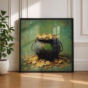 May include: A framed artwork depicts a black cauldron overflowing with gold coins, a green shamrock on its side. Gold coins are scattered around the cauldron against a green and gold background. The artwork is displayed on a wooden floor.