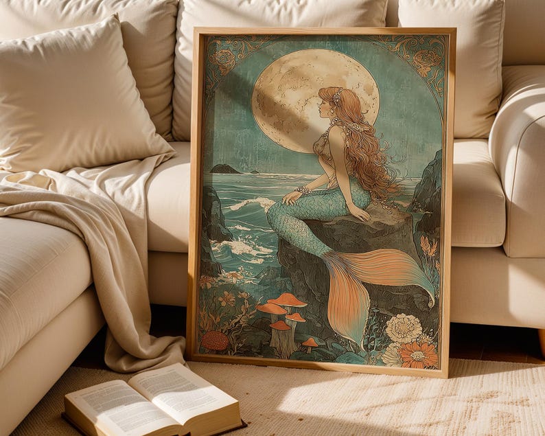 May include: A framed art print featuring a mermaid with long red hair, a turquoise tail, and a seashell top, sitting on a rock. The background includes a full moon, ocean waves, and colorful flowers. The artwork is in a vintage style.