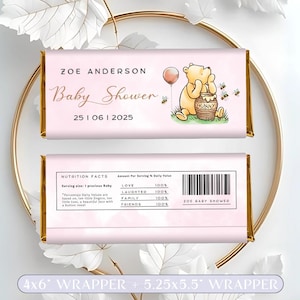 May include: Pink and gold chocolate bar wrapper featuring Winnie the Pooh and a honey pot. The wrapper reads "Zoe Anderson Baby Shower 25 06 2025".