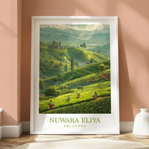 May include: A framed print of a lush green tea plantation in Nuwara Eliya, Sri Lanka. The artwork depicts rolling hills, tea pickers, and a distant mountain range under a bright sky. The text "NUWARA ELIYA SRI LANKA" is at the bottom.