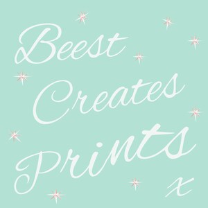May include: White text on a light blue background reads "Beest Creates Prints" with a small "x" at the bottom right. The text is in a cursive font and is surrounded by small white stars.