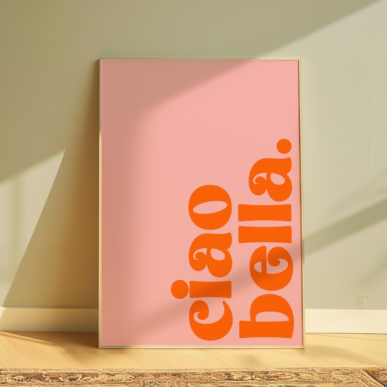 May include: A pink framed poster with the text "ciao bella" in orange.