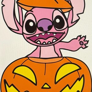 May include: A pink cartoon character with large black eyes and a purple nose, wearing an orange pumpkin hat, emerges from an orange jack-o'-lantern. The jack-o'-lantern has yellow cut-out eyes and a triangular nose.