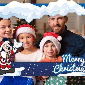 May include: A blue Christmas photo frame with a cloud-like top border and the words "Merry Christmas!" in white script. Mickey Mouse in a Santa suit is on the left. A family of four wearing Santa hats is inside the frame.