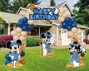 May include: A balloon arch decoration featuring a blue and beige color scheme with three Mickey Mouse baseball player cutouts and a sign at the top that reads HAPPY BIRTHDAY in blue letters with a baseball bat and ball graphic.